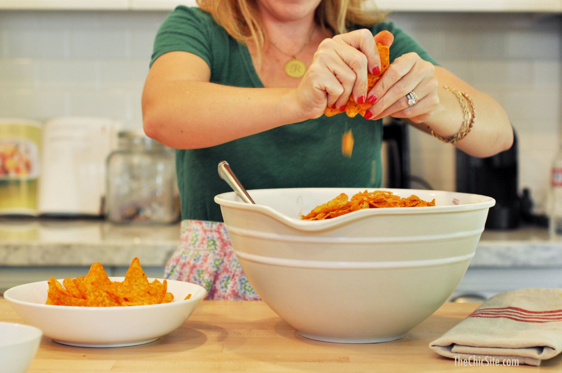 adding chips to salad