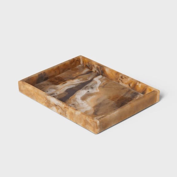 A brown marble tray against a gray background
