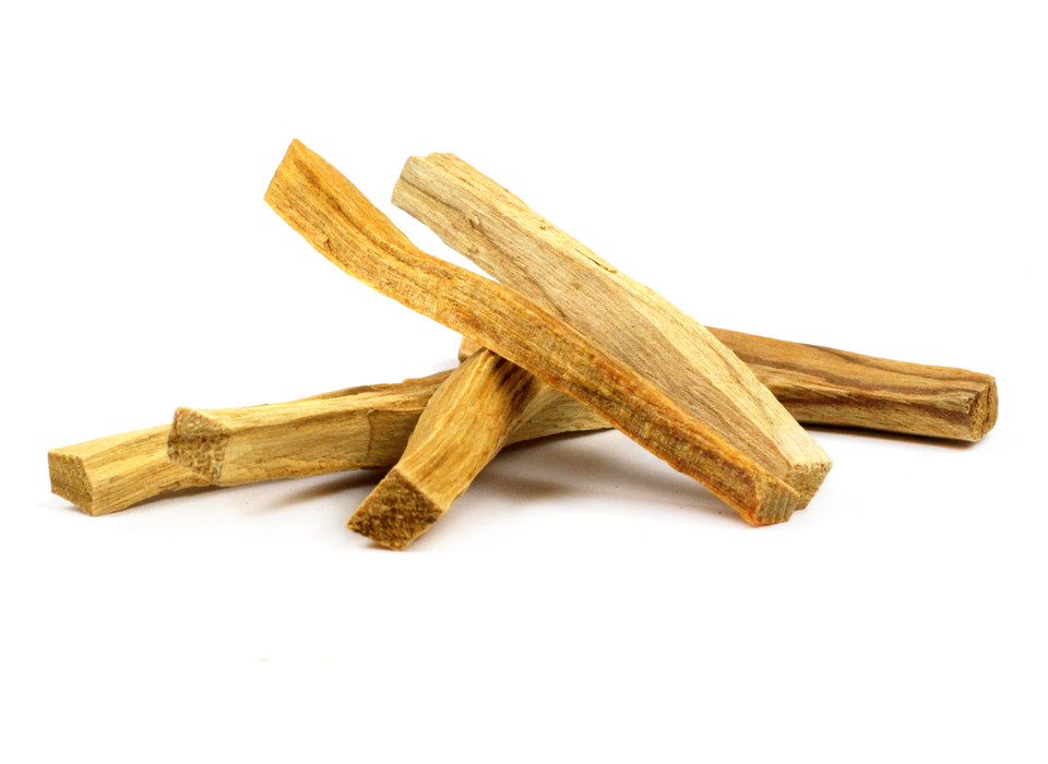 A pile of Palo Santo Sticks against a white background