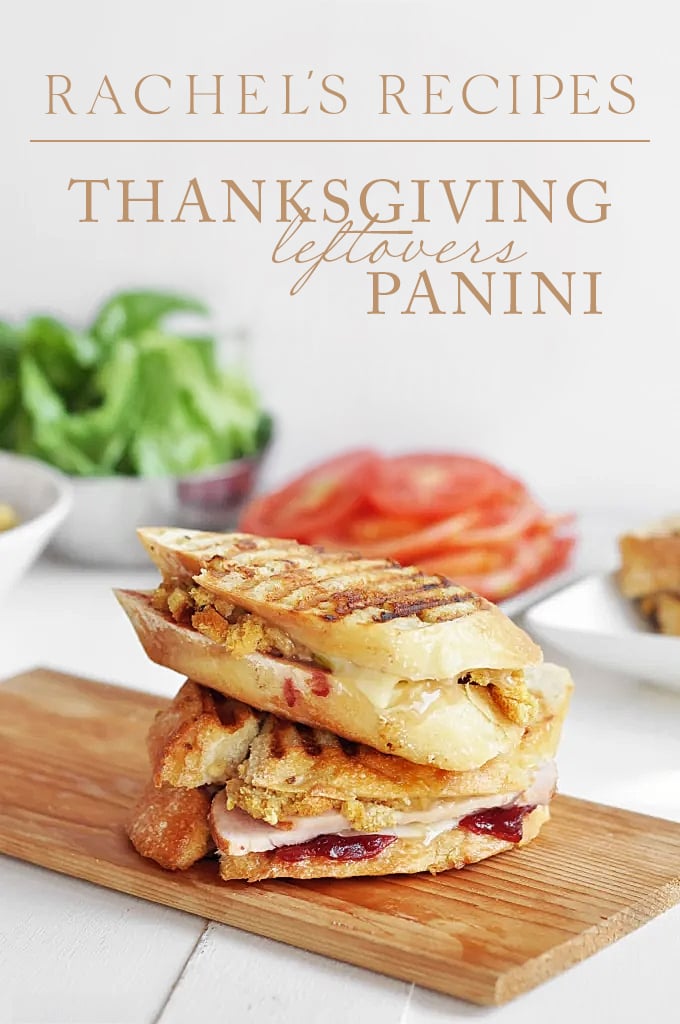 Two halves of a sandwich stacked on top of each other with turkey slices, Provolone, and cranberry sauce on it with text at the top that reads "Rachel's Recipes: Thanksgiving Leftovers Panini"