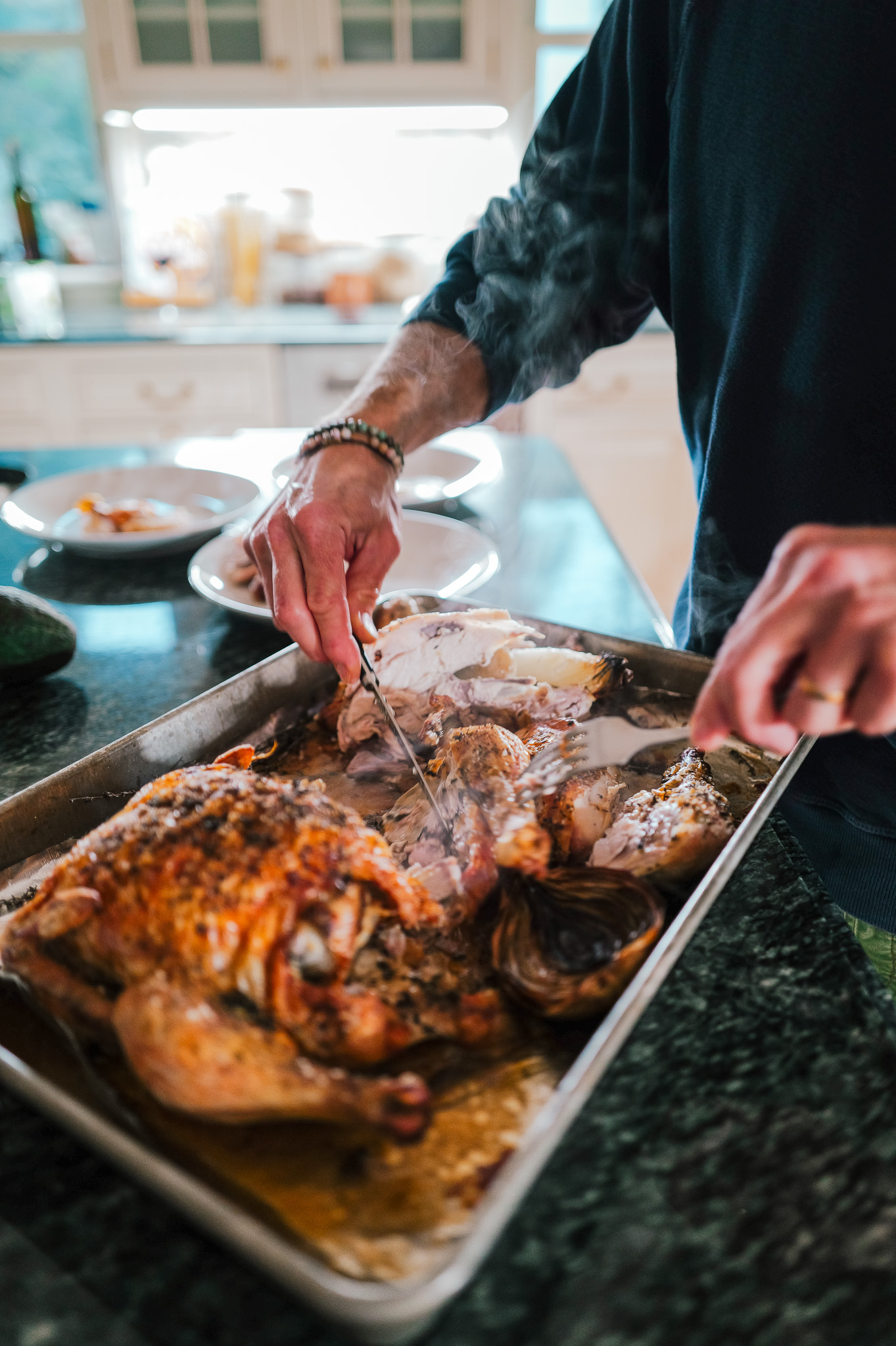 Slicing a golden roast chicken for dinner